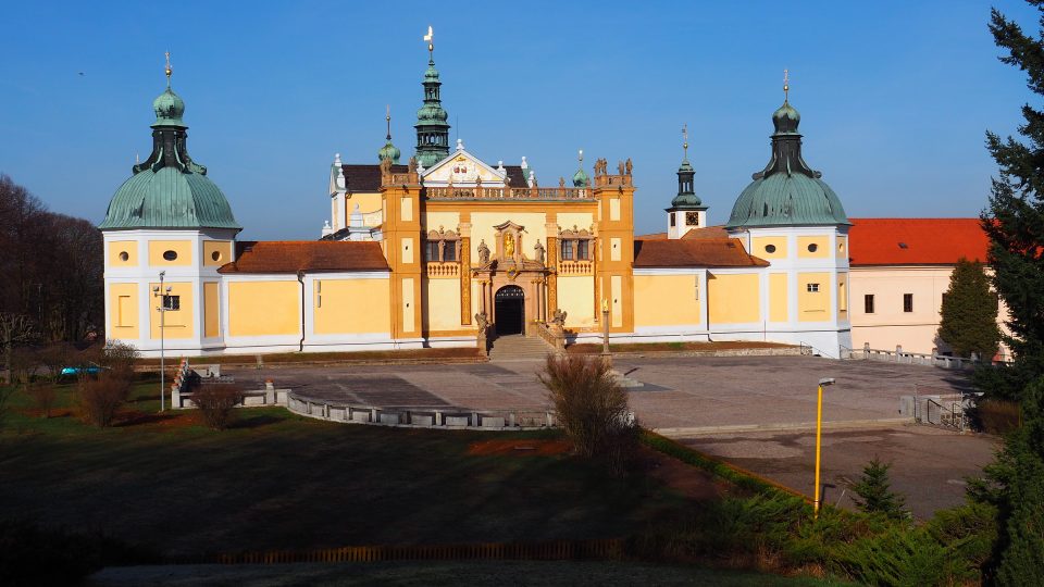 Na prostranství před vstupem do areálu stojí mariánský sloup